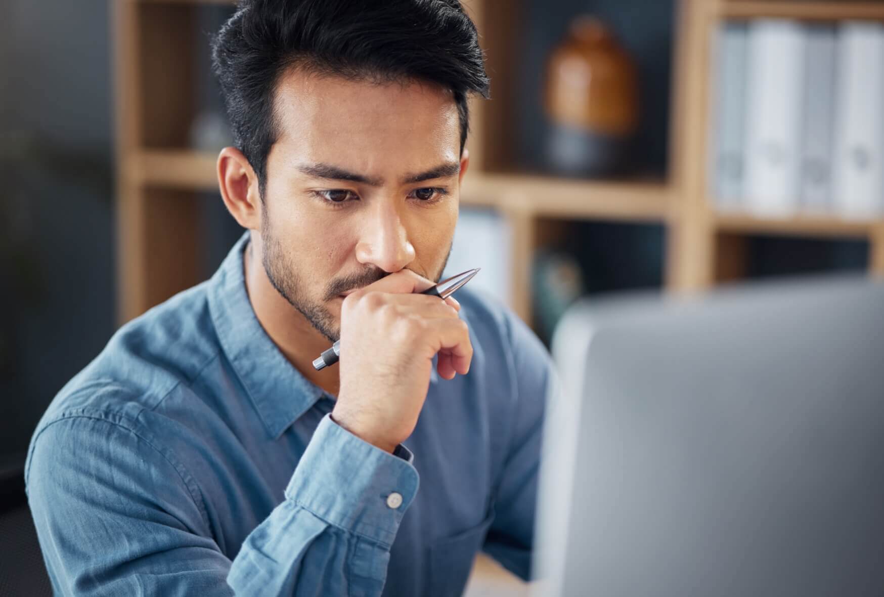 A serious business man and thinking on computer