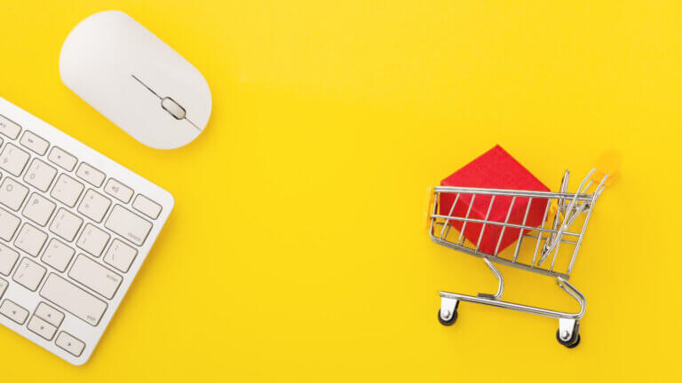 computer mouse and keyboard with shopping cart on the side