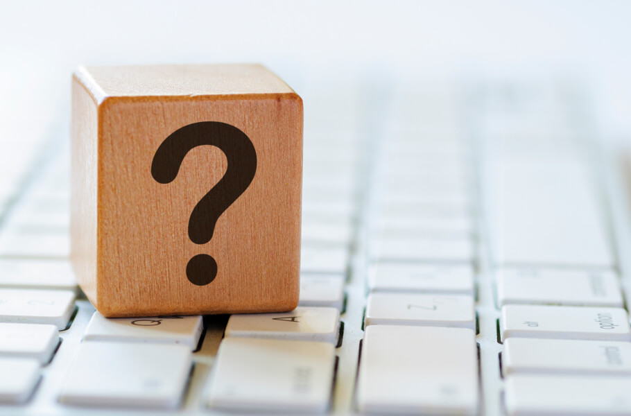 wooden block with question mark icon above the keyboard